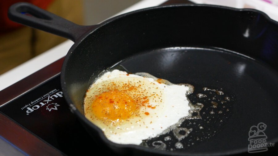 Adding salt, pepper, and cayenne to our egg