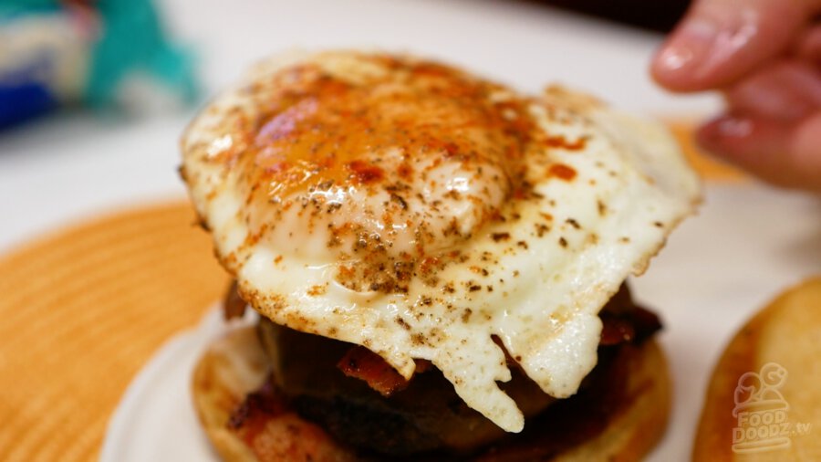 Adding our fried egg on top of the gravy