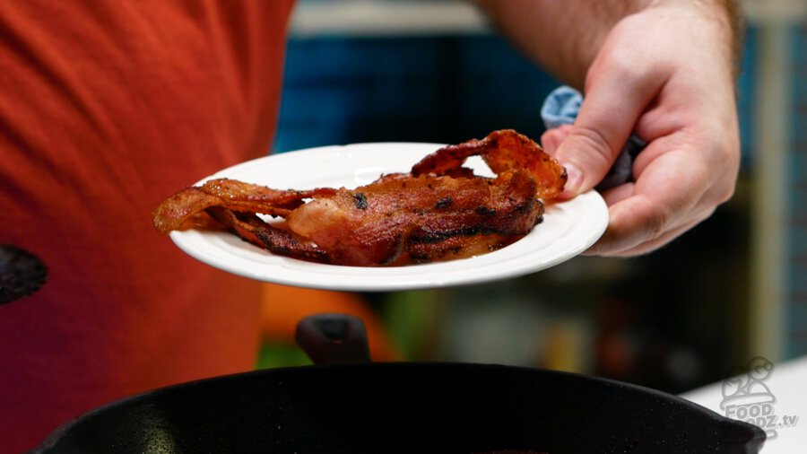 Removing our cooked bacon to a plate