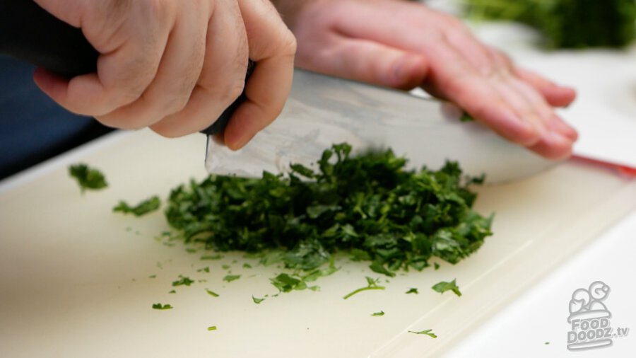 Finely chopping cilantro