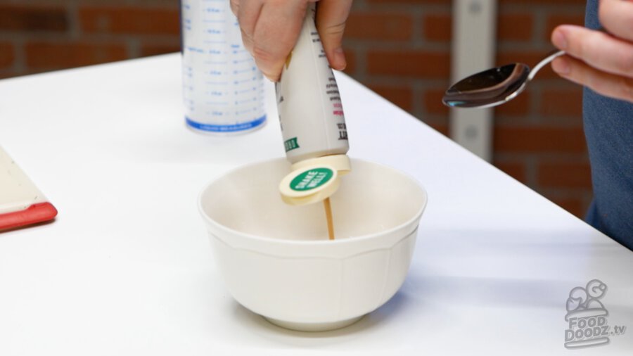 Adding tahini to a bowl