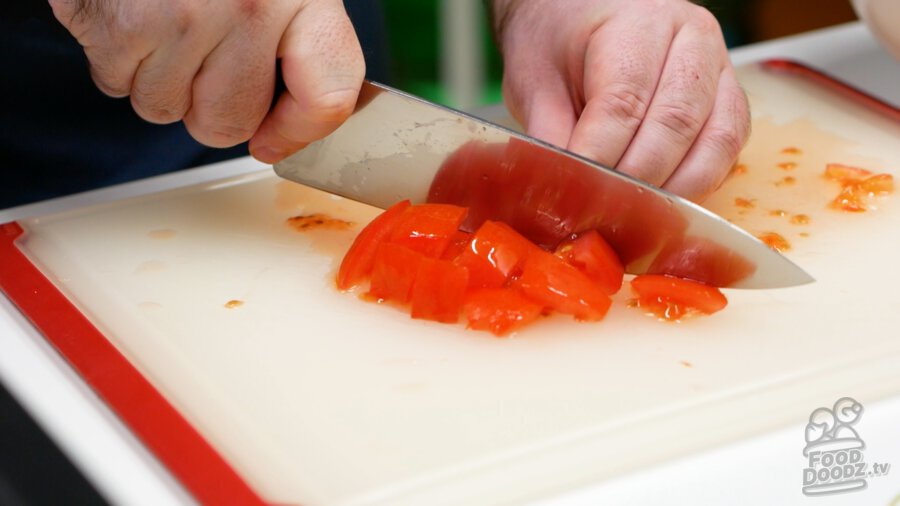 A tomato chopped up into bite-sized pieces