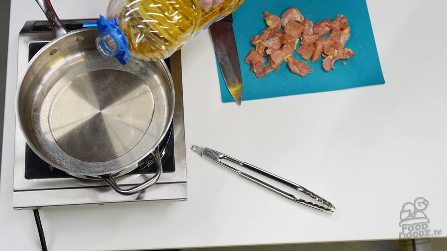 Adding vegetable oil to pan