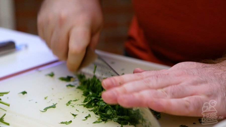 Finely chopping cilantro