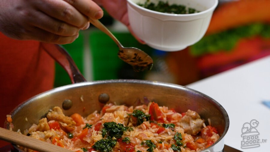 Adding the chimichurri to the rice