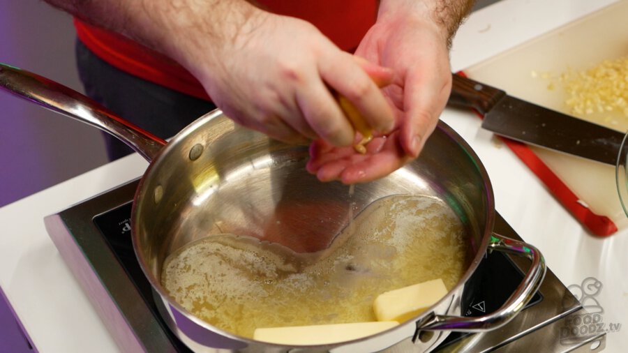 Squeezing lemon juice into pan