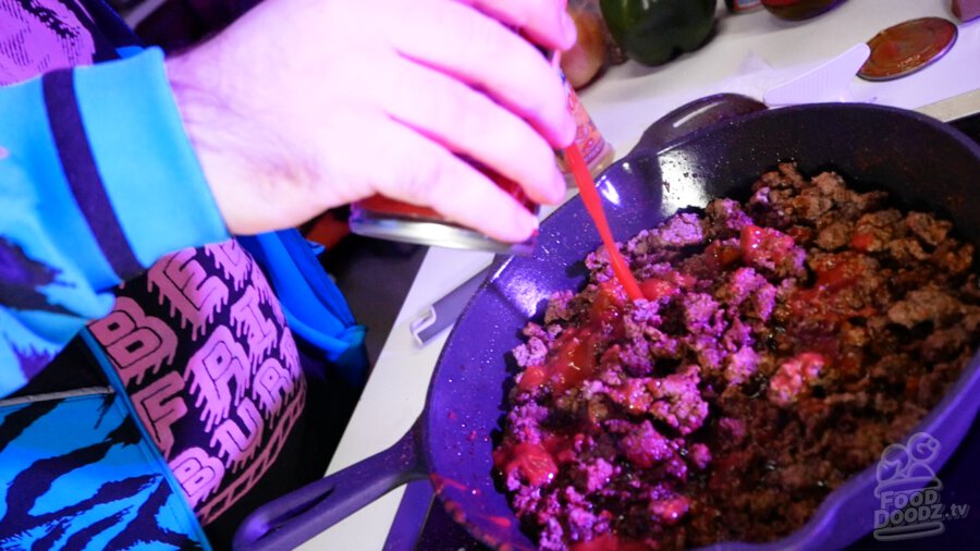 Adding tomato sauce to pan