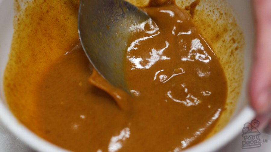 Mixing up the curry block and cooking liquid until the blocks are mostly dissolved