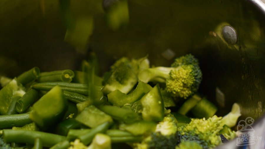 adding the rest of the vegetables to the pot