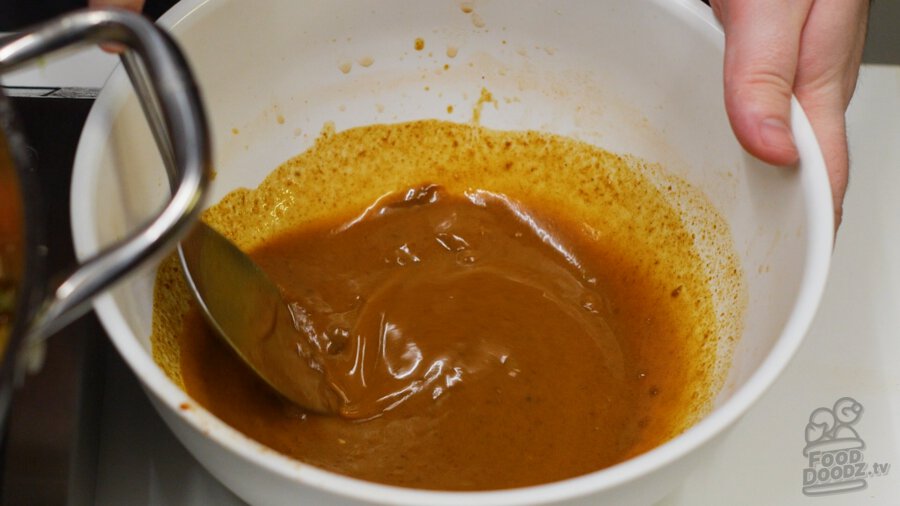 Mixing up the curry block and cooking liquid until the blocks are mostly dissolved