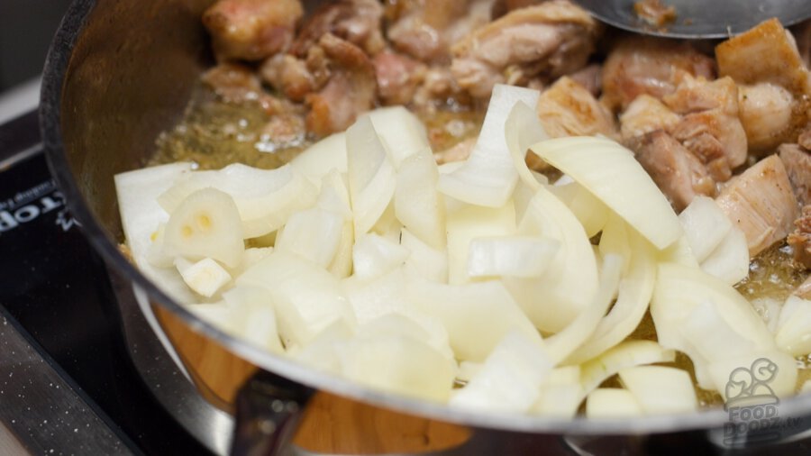 Adding sliced onion to pan