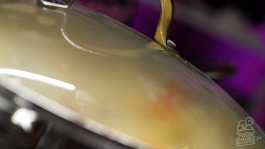 putting lid on boiling pan