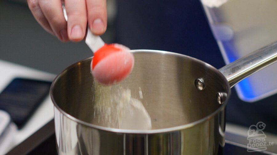 adding flour to pot