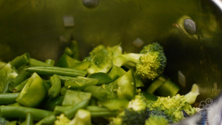 adding the rest of the vegetables to the pot