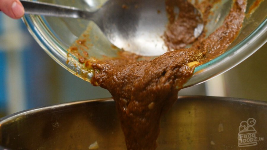 adding our scratchmade curry roux to the pot