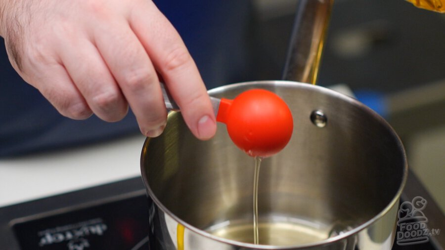 Adding oil to pot