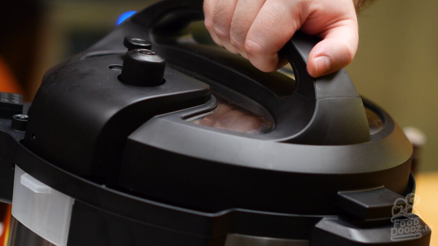 putting lid on pressure cooker