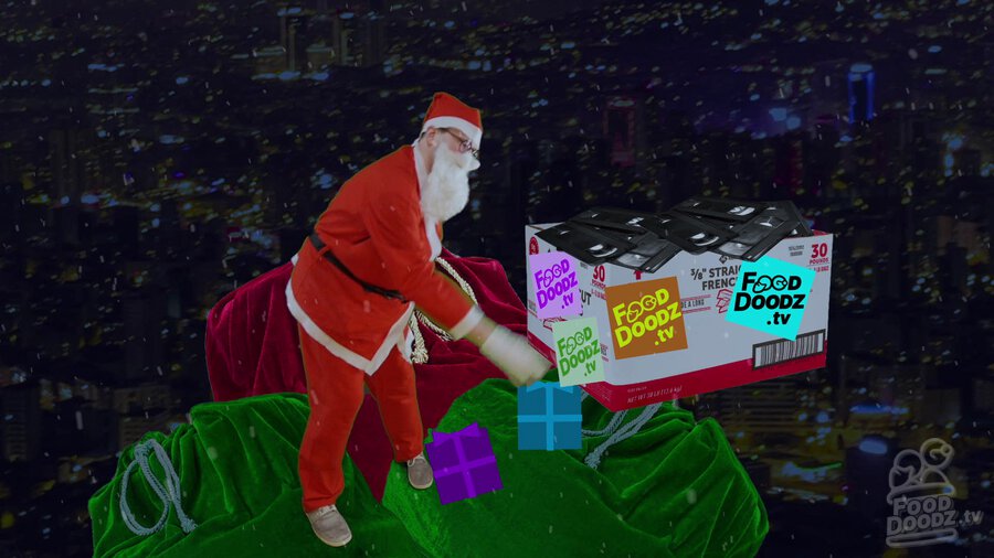 Austin dressed as Santa standing on top of sleigh throwing box of FoodDoodz.tv tapes off of sleigh